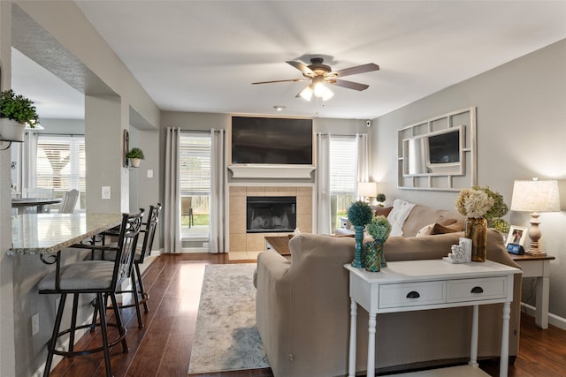 628 Destin Dr, Fort Worth, TX 76131 - living room featuring dark wood-style floors, ceiling fan, baseboards, and a fireplace