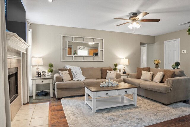 628 Destin Dr, Fort Worth, TX 76131 - living room featuring ceiling fan, a tiled fireplace, and wood finished floors