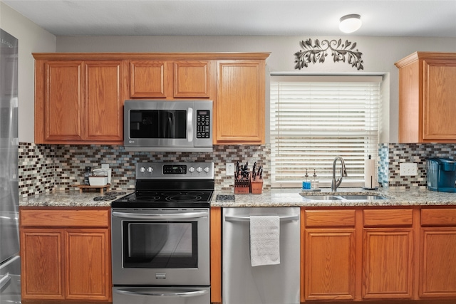 628 Destin Dr, Fort Worth, TX 76131 - kitchen featuring stainless steel appliances, a sink, tasteful backsplash, and light stone countertops