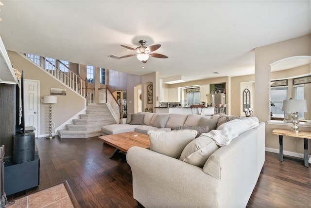 living room with ceiling fan, a healthy amount of sunlight, and dark hardwood / wood-style flooring