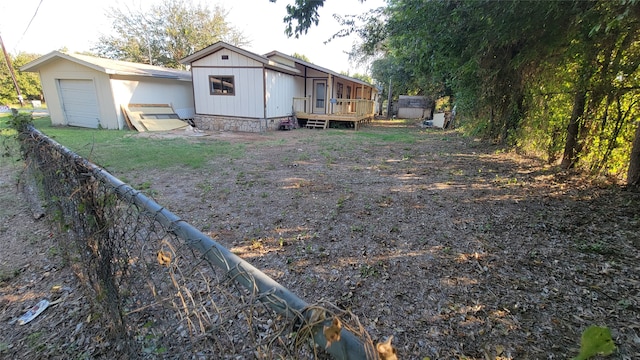 exterior space with an outdoor structure, a deck, and a garage