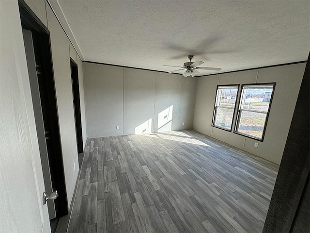 unfurnished bedroom featuring a textured ceiling, hardwood / wood-style flooring, and ceiling fan