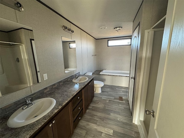 full bathroom featuring hardwood / wood-style flooring, toilet, bathtub / shower combination, vanity, and a textured ceiling