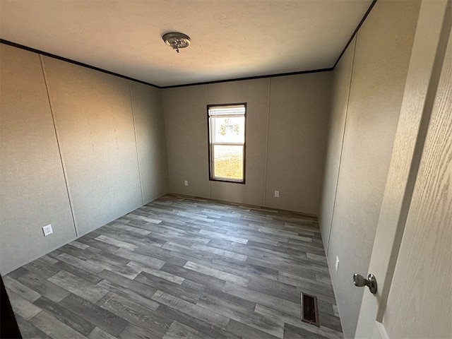 unfurnished room with hardwood / wood-style floors