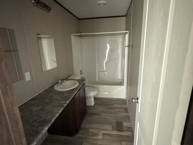 full bathroom with vanity, hardwood / wood-style floors, toilet, and shower / bath combination