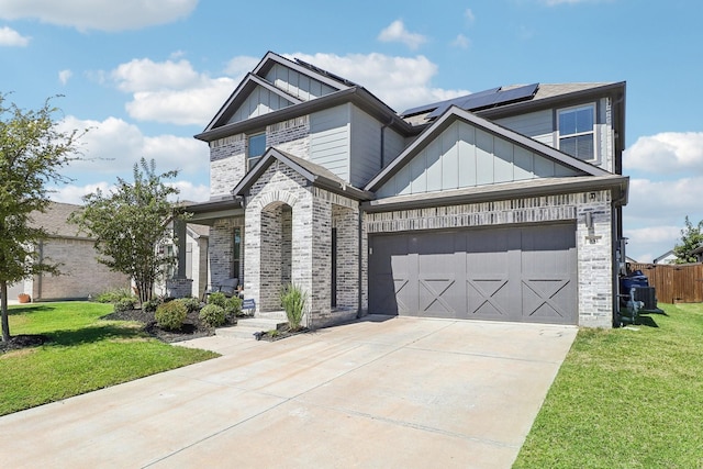 view of front facade featuring solar panels, a garage, and a front lawn