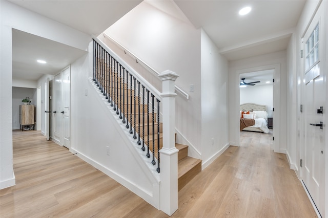 staircase with hardwood / wood-style floors