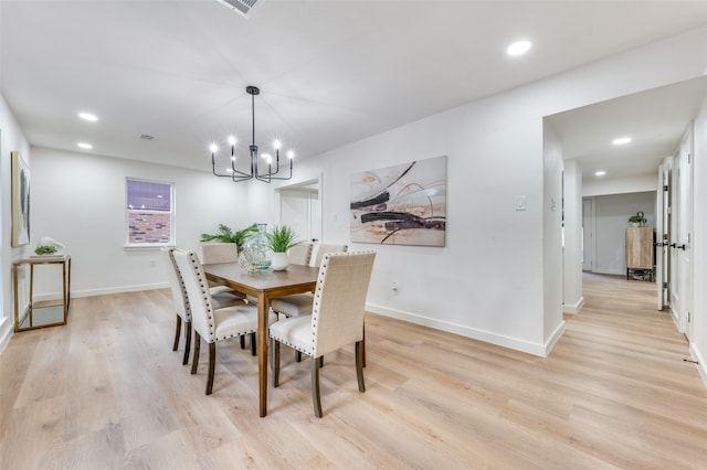 dining room featuring a chandelier and light wood-type flooring