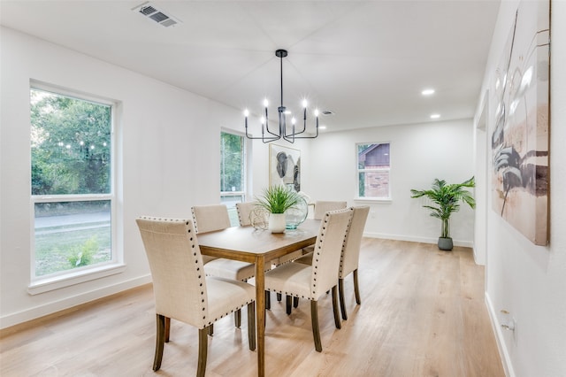 dining room with a wealth of natural light and light hardwood / wood-style flooring