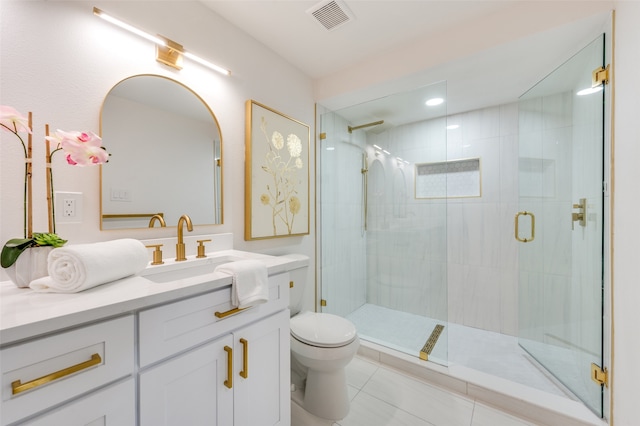 bathroom featuring vanity, a shower with shower door, toilet, and tile patterned flooring