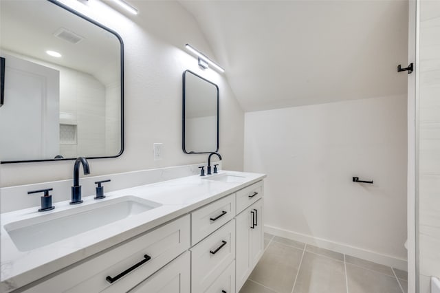 bathroom with vanity, lofted ceiling, and tile patterned floors