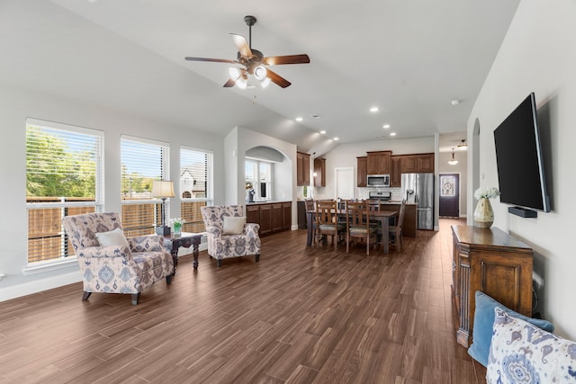 living room with lofted ceiling, ceiling fan, and dark hardwood / wood-style flooring