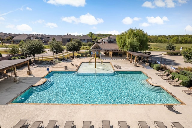 view of swimming pool with a patio area