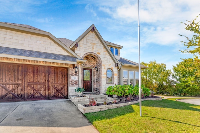 view of front of house with a front lawn and a garage