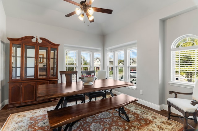 dining room featuring ceiling fan, vaulted ceiling, plenty of natural light, and dark hardwood / wood-style floors