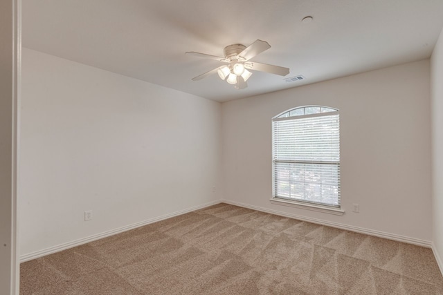 carpeted spare room with ceiling fan