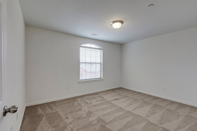 unfurnished room featuring light carpet