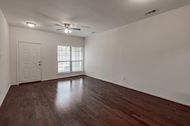 unfurnished room featuring ceiling fan and dark hardwood / wood-style flooring