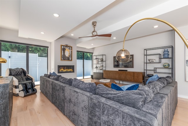 living room with ceiling fan, light hardwood / wood-style floors, and plenty of natural light