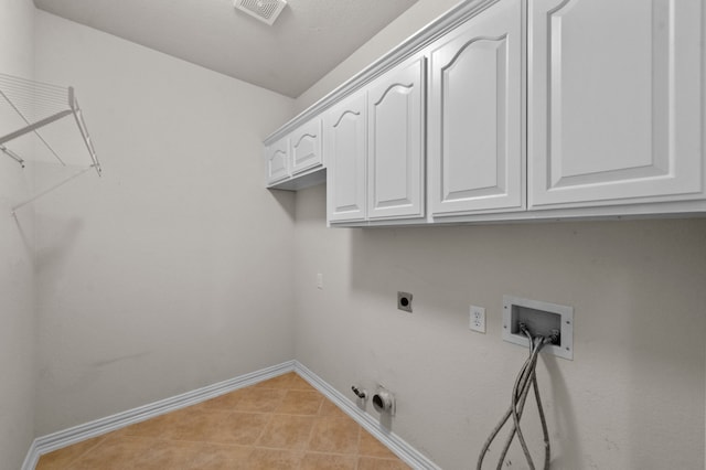 laundry area with light tile patterned flooring, gas dryer hookup, electric dryer hookup, washer hookup, and cabinets