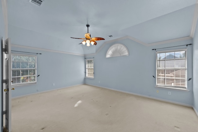 unfurnished room featuring light carpet, ornamental molding, lofted ceiling, and a wealth of natural light