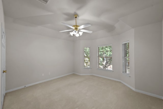 spare room featuring light carpet and ceiling fan