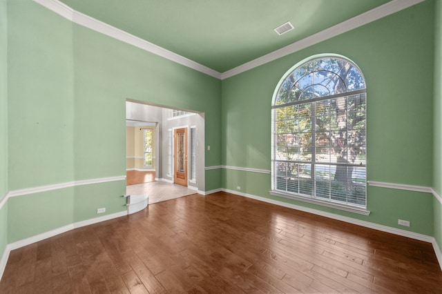 spare room featuring ornamental molding and hardwood / wood-style flooring