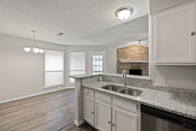 kitchen with dishwasher, sink, vaulted ceiling, white cabinetry, and dark hardwood / wood-style flooring