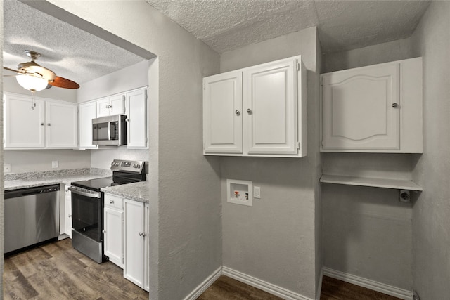 kitchen featuring appliances with stainless steel finishes, a textured ceiling, dark hardwood / wood-style flooring, white cabinetry, and ceiling fan