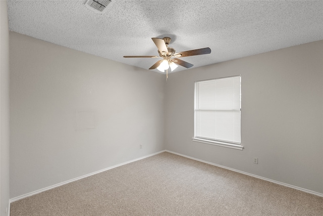 empty room featuring a textured ceiling, carpet flooring, and ceiling fan