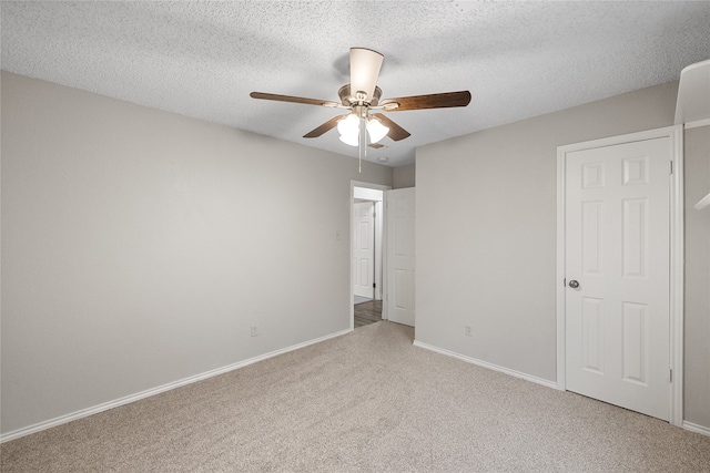 unfurnished bedroom featuring ceiling fan, a textured ceiling, and carpet floors