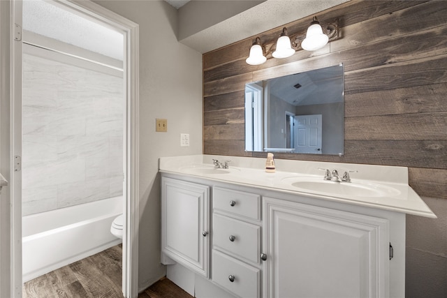 full bathroom featuring vanity, shower / tub combination, hardwood / wood-style flooring, and toilet