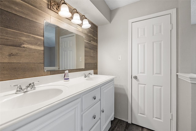 bathroom with vanity, hardwood / wood-style floors, and a textured ceiling