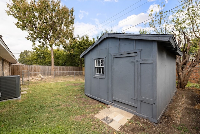 view of outbuilding featuring a lawn and cooling unit