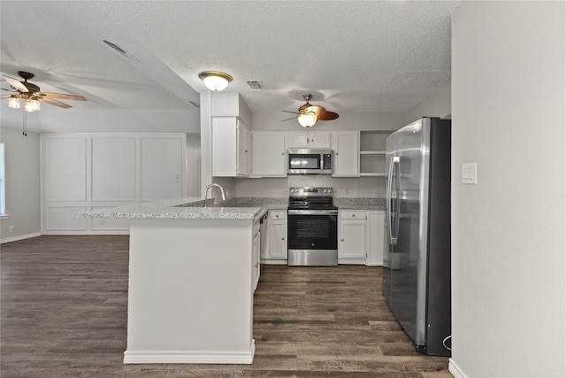 kitchen featuring kitchen peninsula, dark hardwood / wood-style flooring, appliances with stainless steel finishes, white cabinetry, and a textured ceiling