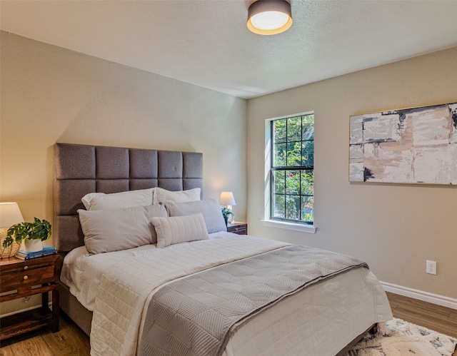 bedroom with hardwood / wood-style floors