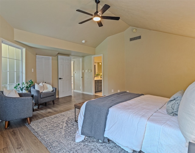 bedroom featuring connected bathroom, ceiling fan, wood-type flooring, and lofted ceiling