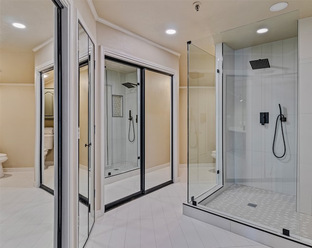 bathroom featuring tile patterned flooring, toilet, a shower with door, and crown molding