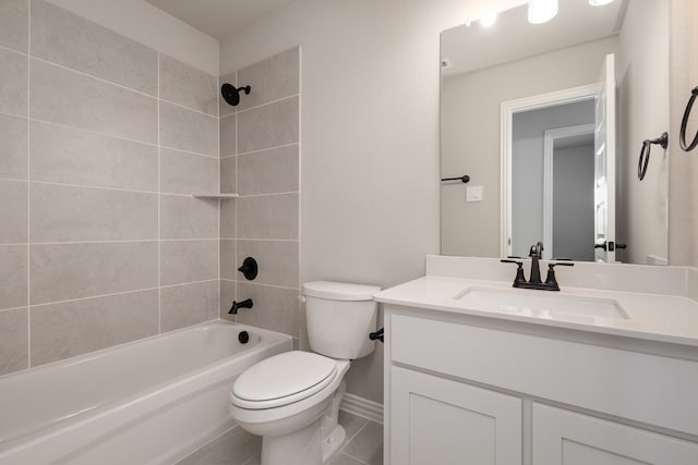 full bathroom with tiled shower / bath, vanity, toilet, and tile patterned floors