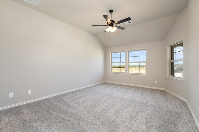 carpeted spare room featuring lofted ceiling and ceiling fan