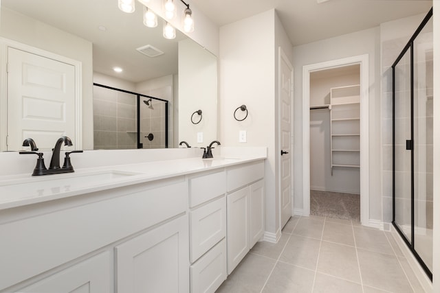 bathroom with vanity, tile patterned floors, and walk in shower