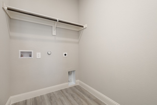 laundry room featuring washer hookup, hardwood / wood-style flooring, electric dryer hookup, and hookup for a gas dryer