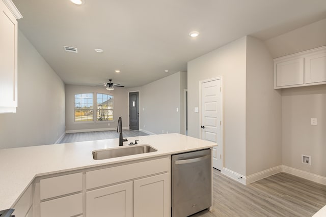 kitchen with sink, light wood-type flooring, stainless steel dishwasher, white cabinets, and ceiling fan