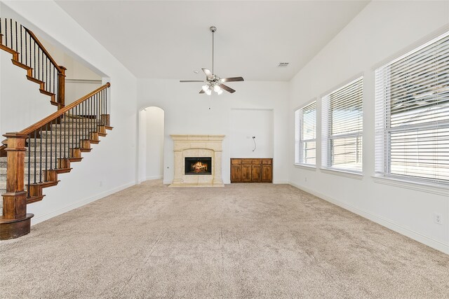 unfurnished living room with ceiling fan with notable chandelier, dark wood-type flooring, and ornamental molding