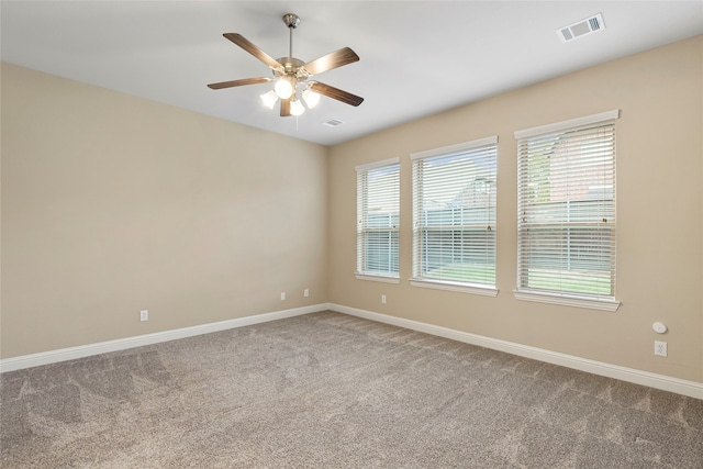 carpeted spare room with ceiling fan and a healthy amount of sunlight