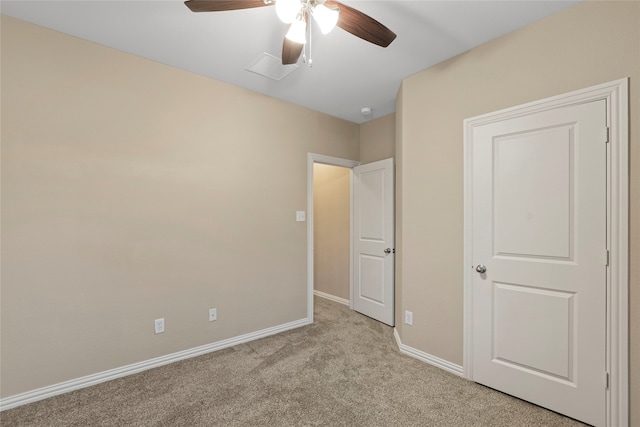 unfurnished bedroom with light carpet and ceiling fan