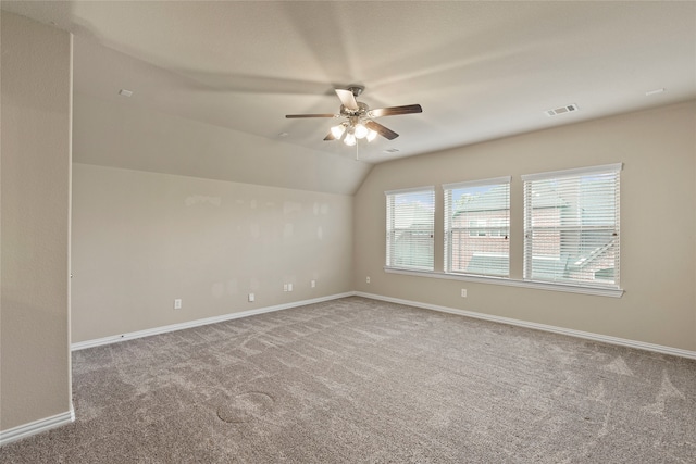 empty room with carpet flooring, ceiling fan, and lofted ceiling