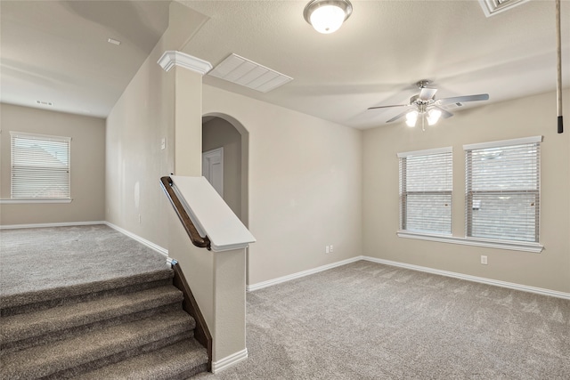 carpeted spare room featuring ceiling fan