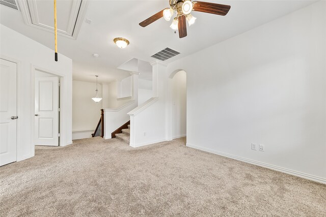 unfurnished bedroom featuring ceiling fan, light colored carpet, and ensuite bath