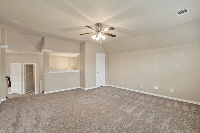 carpeted empty room featuring ceiling fan and lofted ceiling